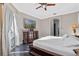 Bright main bedroom featuring flat screen tv, dark wood furniture, and backyard access at 3930 Hydrangea Ct, Oviedo, FL 32766