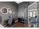 Stylish home office featuring modern décor, tiled floors, and a view to the living room at 3930 Hydrangea Ct, Oviedo, FL 32766