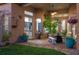 Covered patio area with brick flooring, potted plants, and a view into the home's kitchen at 3930 Hydrangea Ct, Oviedo, FL 32766