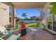 Covered patio view showcasing colorful plants, outdoor seating and the home's spacious, fenced backyard at 3930 Hydrangea Ct, Oviedo, FL 32766