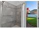 Shower features tile surround and a glass door providing outside view at 3930 Hydrangea Ct, Oviedo, FL 32766