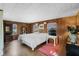 Bedroom with wood paneling, a large bed and natural light at 425 S Woodland St, Winter Garden, FL 34787
