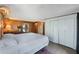 Bedroom with wood paneling, white closets and a bright window at 425 S Woodland St, Winter Garden, FL 34787