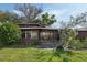 Classic home with a large lawn and a screened-in porch, perfect for enjoying the outdoors at 425 S Woodland St, Winter Garden, FL 34787