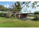 Charming two-story home with mature trees, manicured lawn, and convenient covered carport at 425 S Woodland St, Winter Garden, FL 34787