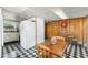 An eat-in kitchen features black and white tile flooring, a staircase and appliances at 425 S Woodland St, Winter Garden, FL 34787
