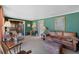 Comfortable living room with carpet, a leather sofa, and views into other rooms at 425 S Woodland St, Winter Garden, FL 34787