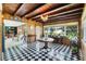 Bright sunroom with checkered floors, connecting the living room to the rest of the home at 425 S Woodland St, Winter Garden, FL 34787