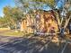 View of building and parking lot with mature trees and blue sky at 4540 Commander Dr # 2236, Orlando, FL 32822