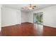 Spacious living room featuring hardwood floors, closet, and sliding glass doors to screened patio at 478 Green Spring Cir, Winter Springs, FL 32708