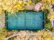 Overhead view of a tennis court surrounded by lush greenery and walking paths at 506 New Providence Promenade # 506, Davenport, FL 33897