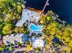 Aerial view showcasing the pool, beach, and lake with its dock at 506 New Providence Promenade # 506, Davenport, FL 33897