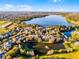 An aerial view of a lakeside community showcasing beautiful landscaping and a serene lake at 506 New Providence Promenade # 506, Davenport, FL 33897