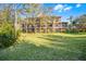 Multi-story condo building with screened patios and lush landscaping at 506 New Providence Promenade # 506, Davenport, FL 33897