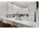 Bright kitchen featuring white cabinets, modern appliances, and breakfast bar seating at 506 New Providence Promenade # 506, Davenport, FL 33897
