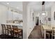 Kitchen and dining area showcasing white cabinetry and eat-in breakfast bar at 506 New Providence Promenade # 506, Davenport, FL 33897