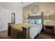 Bedroom with a wooden bed frame, neutral walls, and ample closet space at 506 New Providence Promenade # 506, Davenport, FL 33897