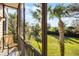 Screened patio with seating, offering lush green views at 506 New Providence Promenade # 506, Davenport, FL 33897