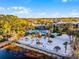 Beautiful community pool with beach area, lush landscaping, and lounge chairs at 506 New Providence Promenade # 506, Davenport, FL 33897