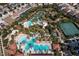 Aerial view of the community with the pool, lazy river, tennis courts, and playground at 5251 Wildwood Way, Davenport, FL 33837