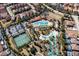 Aerial view features a resort-style pool, lazy river, tennis courts, and manicured landscaping at 5251 Wildwood Way, Davenport, FL 33837