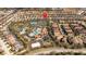 Community aerial view showcases a resort-style pool, clubhouse, playground, and tennis courts at 5251 Wildwood Way, Davenport, FL 33837