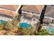 Aerial view of the pool, patio and homes with well-maintained yards and screened enclosures at 5251 Wildwood Way, Davenport, FL 33837