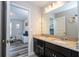 Bathroom featuring a granite countertop, double sinks, and decoratively-framed mirror at 5251 Wildwood Way, Davenport, FL 33837