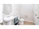Charming half bath features an oval mirror, pedestal sink and lovely decor throughout at 5251 Wildwood Way, Davenport, FL 33837
