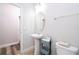 Bathroom featuring pedestal sink, gray decor, with vinyl flooring leading to the door at 5251 Wildwood Way, Davenport, FL 33837