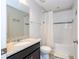 Well-maintained bathroom featuring a shower-tub combo with white tile and a granite countertop vanity at 5251 Wildwood Way, Davenport, FL 33837