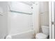 Clean bathroom with a tiled tub and shower combination, featuring white fixtures and a shower curtain at 5251 Wildwood Way, Davenport, FL 33837