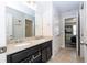 Bathroom boasts double sinks with granite countertops and a doorway view to the adjacent bedroom at 5251 Wildwood Way, Davenport, FL 33837