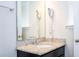 Bathroom vanity with granite countertop, and wall mounted hair dryers at 5251 Wildwood Way, Davenport, FL 33837