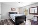 Cozy bedroom featuring a queen-size bed, wood-look flooring, and a window with natural light at 5251 Wildwood Way, Davenport, FL 33837
