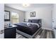 Comfortable bedroom features a plush bed, stylish decor, and natural light from the window at 5251 Wildwood Way, Davenport, FL 33837