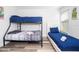 Bright bedroom features a bunk bed, a twin bed, and playful wall decor for a fun and inviting space at 5251 Wildwood Way, Davenport, FL 33837