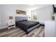 Bright bedroom featuring modern decor, a large bed, and a window with natural light at 5251 Wildwood Way, Davenport, FL 33837