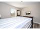 Serene bedroom featuring a comfortable bed, natural light, and a mounted television for relaxation at 5251 Wildwood Way, Davenport, FL 33837