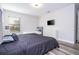 Cozy bedroom with a king bed, dresser, and a twin bed for additional sleeping space at 5251 Wildwood Way, Davenport, FL 33837