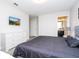 Bedroom featuring a king bed, dresser, and mounted tv on the wall at 5251 Wildwood Way, Davenport, FL 33837