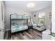 This bedroom boasts a bunk bed with modern decor, with a full-size bed off to the side at 5251 Wildwood Way, Davenport, FL 33837