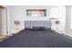 Comfortable bedroom with a king size bed, contemporary art, and ample natural light at 5251 Wildwood Way, Davenport, FL 33837