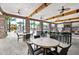 Community area with tables, chairs, and mounted television overlooking the community pool and water slide at 5251 Wildwood Way, Davenport, FL 33837