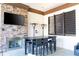 Close up view of a community fireplace with a mounted television and table with chairs at 5251 Wildwood Way, Davenport, FL 33837