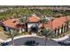 Aerial view of a community center with a large pool surrounded by palm trees and residences at 5251 Wildwood Way, Davenport, FL 33837