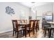 Bright dining room showcasing a wooden table with seating for eight and stainless steel refrigerator at 5251 Wildwood Way, Davenport, FL 33837
