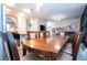 Open concept dining room with a large wooden table and chairs adjacent to the living area at 5251 Wildwood Way, Davenport, FL 33837