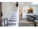A welcoming entryway features wood-look floors, staircase, and a view into the dining area at 5251 Wildwood Way, Davenport, FL 33837