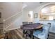 Bright game room showcasing a poker table, staircase, stylish chairs, and view of the kitchen at 5251 Wildwood Way, Davenport, FL 33837